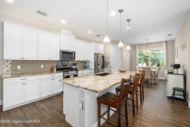 3631 Stabane Pl, Melbourne, FL 32940 - kitchen featuring appliances with stainless steel finishes, a sink, a center island with sink, dark wood-type flooring, and recessed lighting