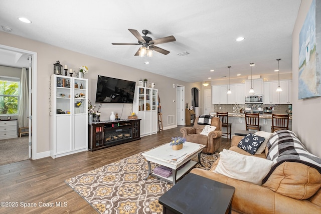 3631 Stabane Pl, Melbourne, FL 32940 - living area with a ceiling fan, wood finished floors, baseboards, recessed lighting, and arched walkways