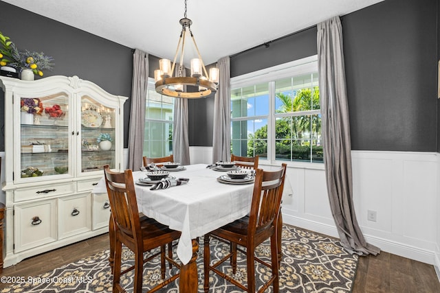 3631 Stabane Pl, Melbourne, FL 32940 - dining room with a chandelier, a wainscoted wall, dark wood finished floors, and a decorative wall