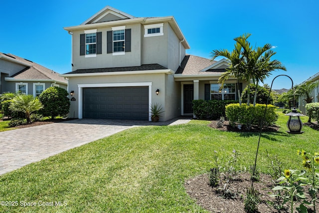 3631 Stabane Pl, Melbourne, FL 32940 - view of front facade with a garage, stucco siding, a front yard, and decorative driveway