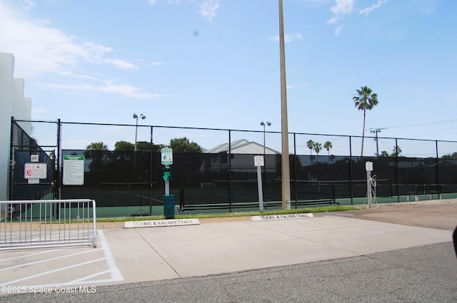 view of tennis court featuring fence