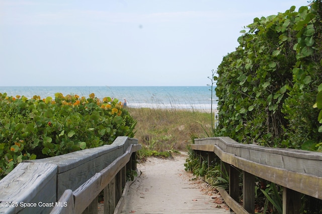 view of home's community featuring view of water and beach