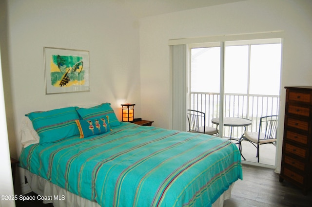 bedroom featuring access to outside and wood finished floors