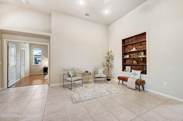 178 Cove Loop Dr, Merritt Island, FL 32953 - living area with built in features, a towering ceiling, light tile patterned floors, baseboards, and recessed lighting