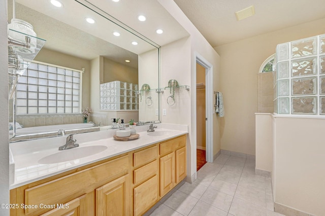 178 Cove Loop Dr, Merritt Island, FL 32953 - full bathroom with recessed lighting, tile patterned flooring, baseboards, double vanity, and walk in shower