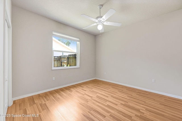 178 Cove Loop Dr, Merritt Island, FL 32953 - spare room with light wood finished floors, ceiling fan, baseboards, and a textured ceiling
