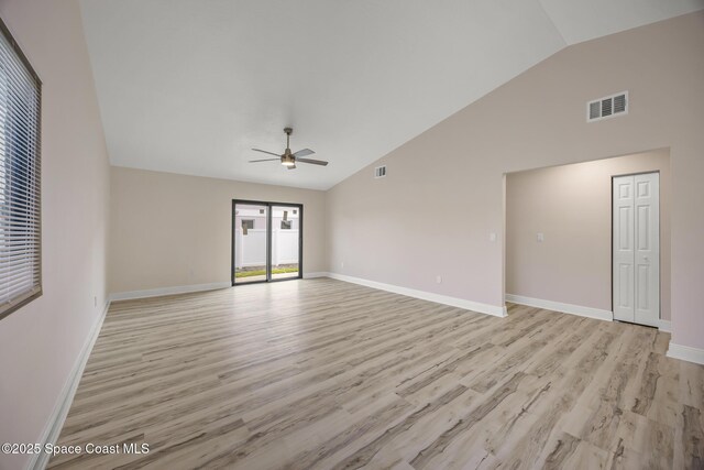 1411 Club Gardens Dr NE, Palm Bay, FL 32905 - unfurnished living room with ceiling fan, light wood-style flooring, high vaulted ceiling, and baseboards