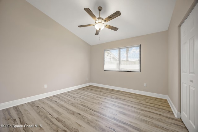 1411 Club Gardens Dr NE, Palm Bay, FL 32905 - unfurnished bedroom with vaulted ceiling, light wood finished floors, baseboards, and ceiling fan