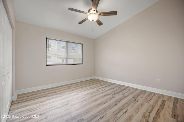 1411 Club Gardens Dr NE, Palm Bay, FL 32905 - unfurnished bedroom with a closet, light wood-type flooring, baseboards, ceiling fan, and lofted ceiling