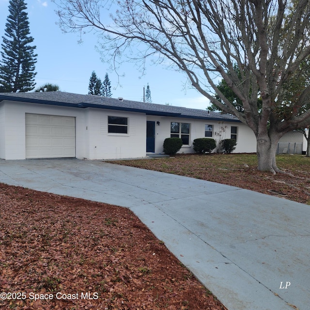 ranch-style house featuring a garage and driveway