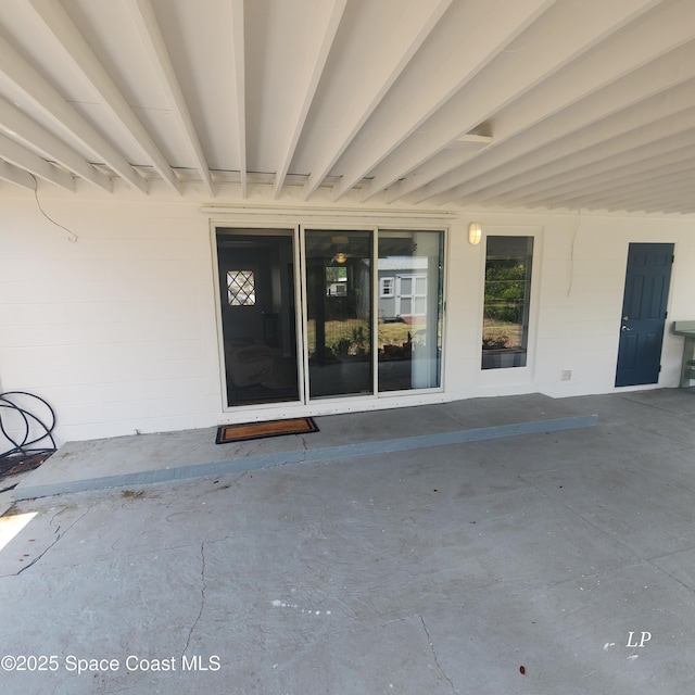 doorway to property with concrete block siding