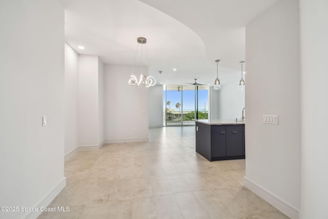 spare room with a wall of windows, baseboards, arched walkways, a sink, and recessed lighting