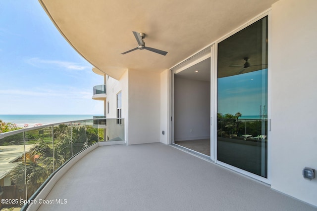 balcony featuring a ceiling fan and a water view