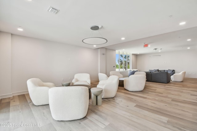 living room featuring light wood-type flooring, recessed lighting, and baseboards