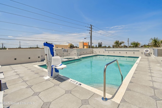 community pool featuring a patio area