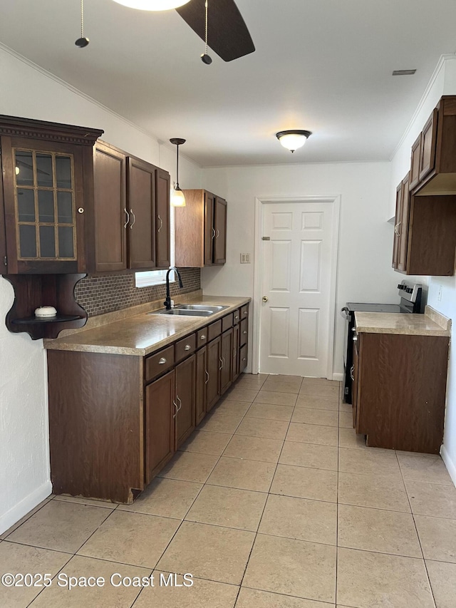 kitchen with a sink, stainless steel electric range, dark brown cabinets, and light tile patterned flooring