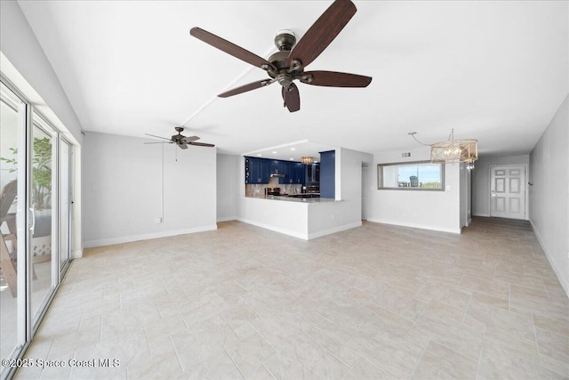 2203 Atlantic St Unit 715, Melbourne Beach, FL 32951 - unfurnished living room with a chandelier, a ceiling fan, and baseboards