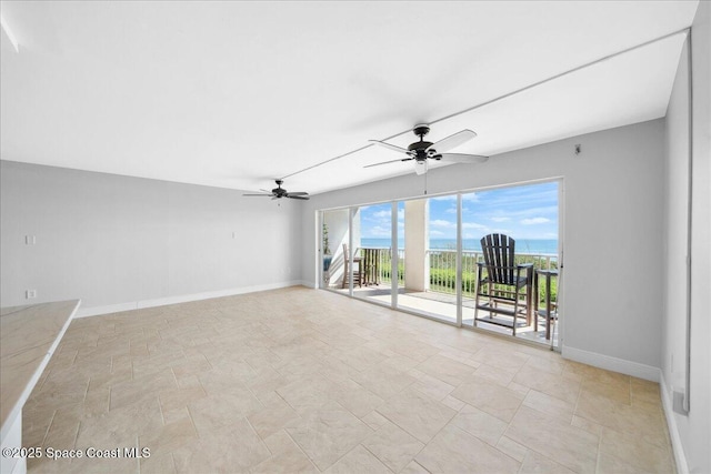 2203 Atlantic St Unit 715, Melbourne Beach, FL 32951 - spare room featuring baseboards, a ceiling fan, and stone finish flooring