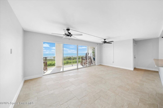 2203 Atlantic St Unit 715, Melbourne Beach, FL 32951 - unfurnished room with baseboards, ceiling fan, and light stone finish floors