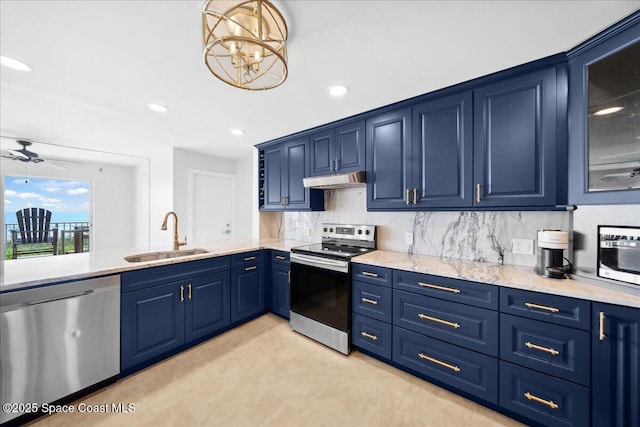 2203 Atlantic St Unit 715, Melbourne Beach, FL 32951 - kitchen featuring appliances with stainless steel finishes, blue cabinetry, a sink, under cabinet range hood, and tasteful backsplash