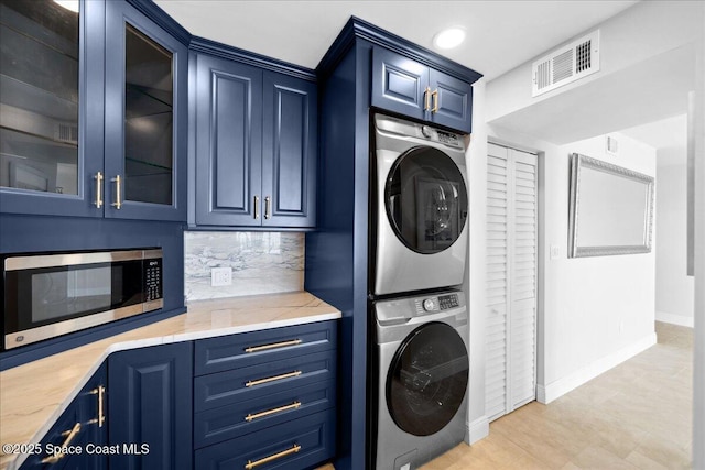 2203 Atlantic St Unit 715, Melbourne Beach, FL 32951 - washroom with stacked washing machine and dryer, baseboards, light tile patterned floors, and recessed lighting