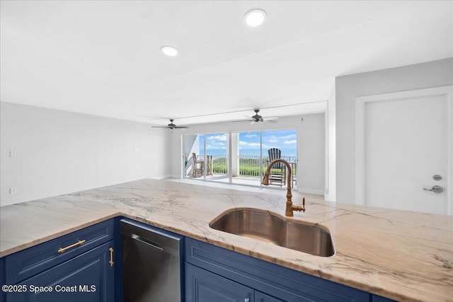2203 Atlantic St Unit 715, Melbourne Beach, FL 32951 - kitchen with stainless steel dishwasher, a sink, blue cabinets, light stone counters, and a ceiling fan