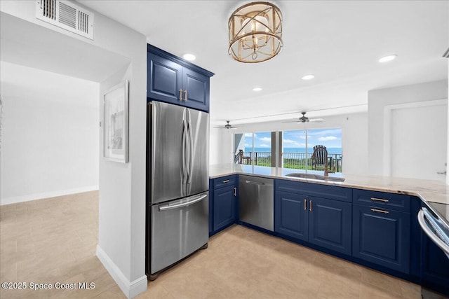 2203 Atlantic St Unit 715, Melbourne Beach, FL 32951 - kitchen with appliances with stainless steel finishes, blue cabinets, a sink, recessed lighting, and a ceiling fan