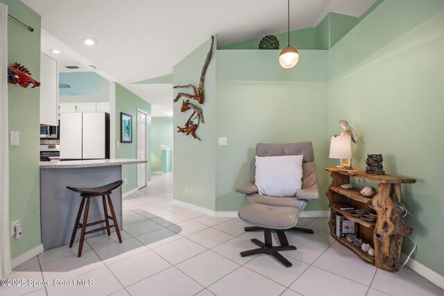 644 Sheridan Woods Dr, Melbourne, FL 32904 - sitting room featuring light tile patterned flooring, baseboards, vaulted ceiling, and recessed lighting