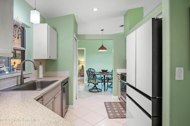 644 Sheridan Woods Dr, Melbourne, FL 32904 - kitchen featuring a sink, freestanding refrigerator, stove, light countertops, and decorative light fixtures