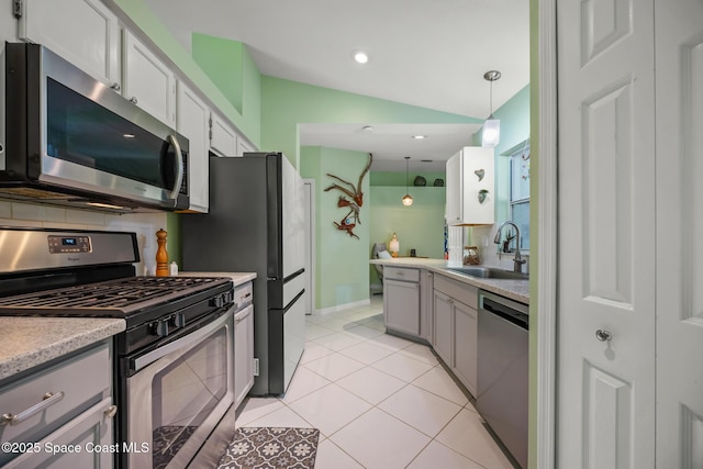 644 Sheridan Woods Dr, Melbourne, FL 32904 - kitchen with stainless steel appliances, a sink, lofted ceiling, light countertops, and hanging light fixtures