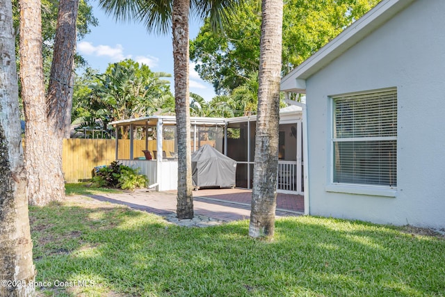 644 Sheridan Woods Dr, Melbourne, FL 32904 - view of yard featuring a patio and a sunroom