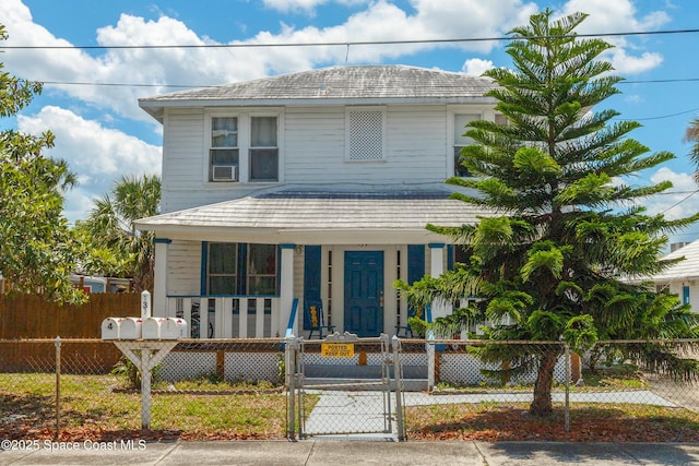 137 Peachtree St, Cocoa, FL 32922 - view of front facade featuring a porch, a fenced front yard, and a gate