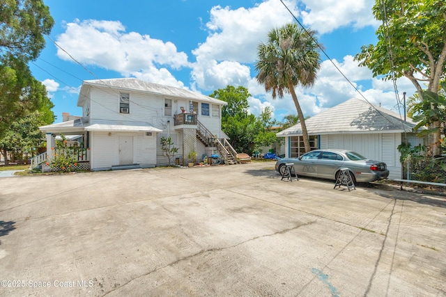 137 Peachtree St, Cocoa, FL 32922 - view of side of home with stairs, covered porch, and concrete driveway