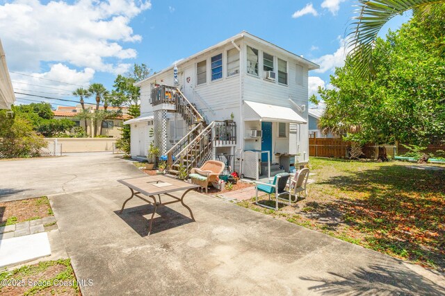 137 Peachtree St, Cocoa, FL 32922 - back of house featuring stairs, fence, and a patio