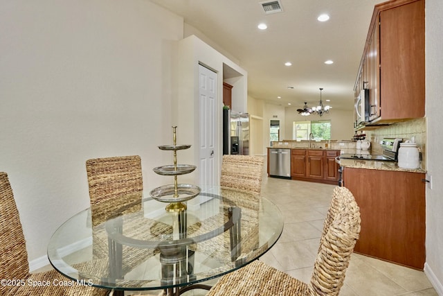 6227 Thames Pl, Vero Beach, FL 32966 - dining area with a chandelier, recessed lighting, light tile patterned flooring, and baseboards