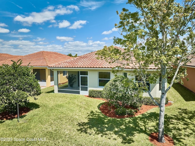 6227 Thames Pl, Vero Beach, FL 32966 - rear view of property featuring stucco siding, a yard, a tiled roof, and a sunroom