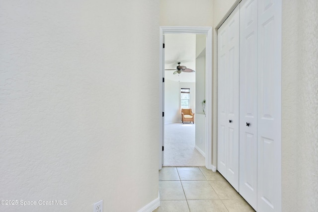 6227 Thames Pl, Vero Beach, FL 32966 - corridor featuring baseboards, light tile patterned flooring, and a textured wall