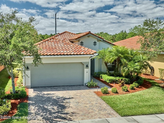 6227 Thames Pl, Vero Beach, FL 32966 - mediterranean / spanish home with a garage, driveway, a tile roof, and stucco siding