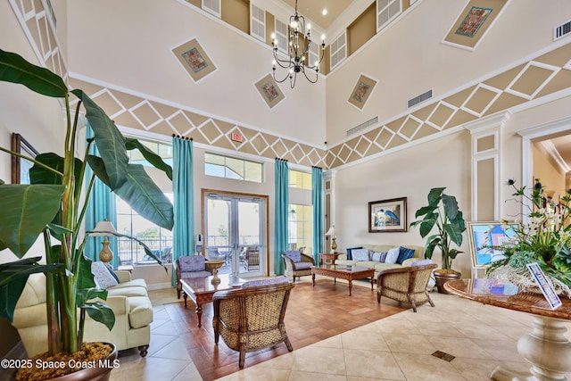 6227 Thames Pl, Vero Beach, FL 32966 - tiled living area with a high ceiling, a chandelier, french doors, and ornamental molding