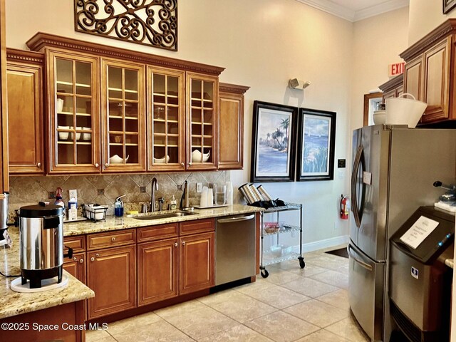 6227 Thames Pl, Vero Beach, FL 32966 - kitchen with appliances with stainless steel finishes, a sink, tasteful backsplash, baseboards, and light stone countertops