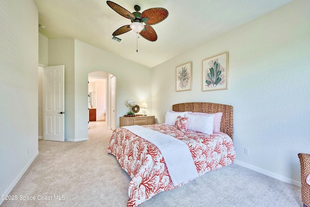 6227 Thames Pl, Vero Beach, FL 32966 - carpeted bedroom with arched walkways, baseboards, ensuite bath, a ceiling fan, and vaulted ceiling