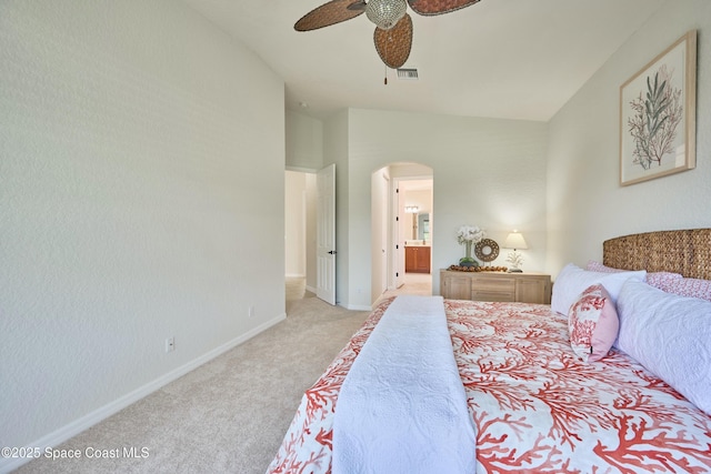 6227 Thames Pl, Vero Beach, FL 32966 - bedroom with arched walkways, light carpet, baseboards, ensuite bathroom, and a ceiling fan