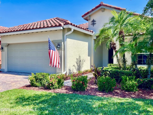 6227 Thames Pl, Vero Beach, FL 32966 - view of property exterior featuring a tiled roof, an attached garage, stucco siding, and driveway