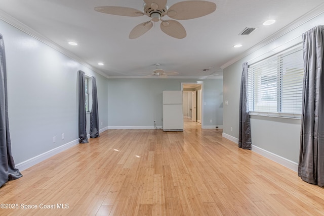 empty room with ceiling fan, crown molding, light wood finished floors, recessed lighting, and baseboards