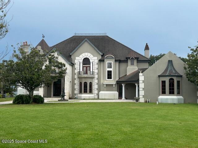 view of front of property with a front yard and stucco siding