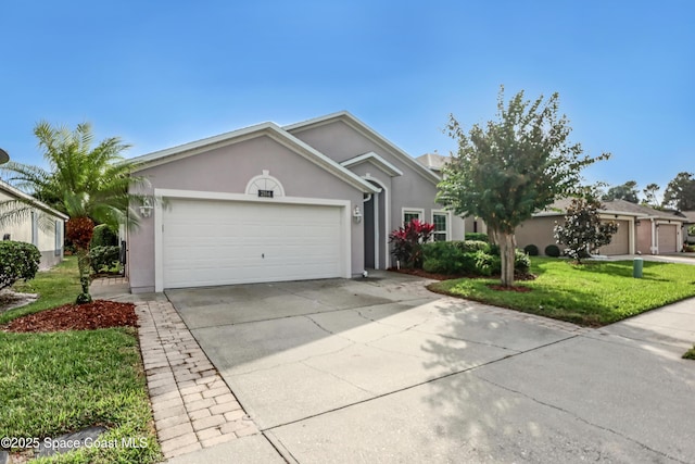 view of front of property with stucco siding, concrete driveway, an attached garage, and a front yard