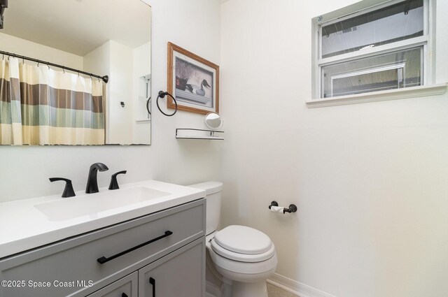 1410 Vander Ave SE, Palm Bay, FL 32909 - bathroom featuring toilet, vanity, baseboards, and curtained shower