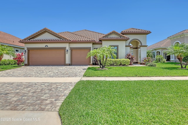 2922 Addison Dr, Melbourne, FL 32940 - mediterranean / spanish-style home featuring an attached garage, stucco siding, a front lawn, decorative driveway, and a tiled roof
