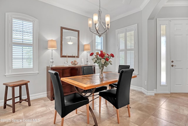 2922 Addison Dr, Melbourne, FL 32940 - dining area featuring crown molding, a chandelier, baseboards, light tile patterned flooring, and arched walkways