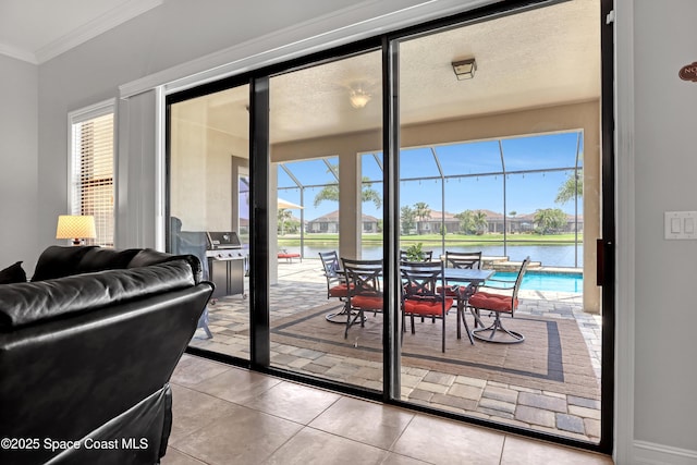 2922 Addison Dr, Melbourne, FL 32940 - entryway featuring a sunroom, ornamental molding, a water view, tile patterned flooring, and a residential view